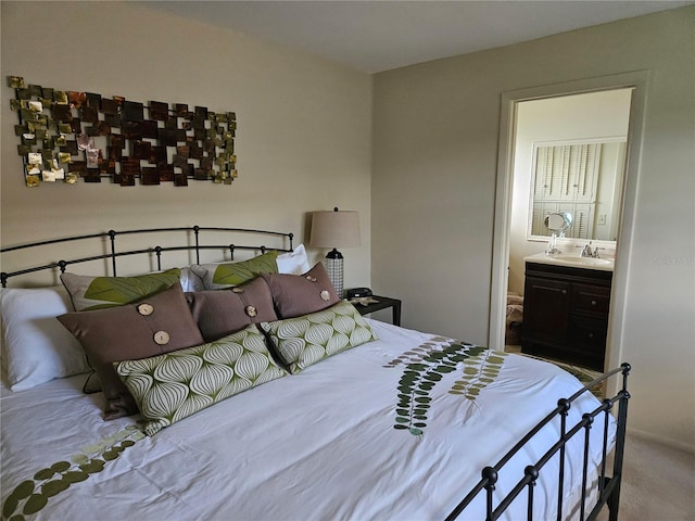 carpeted bedroom featuring ensuite bath and sink