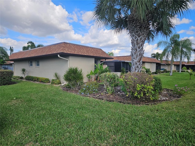 view of home's exterior with a lawn