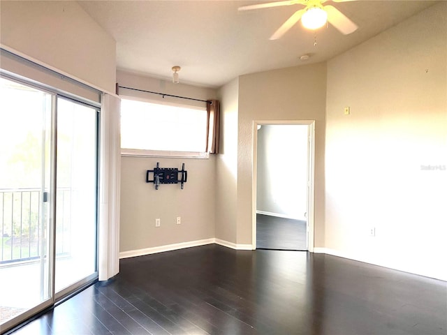 spare room with dark hardwood / wood-style floors and ceiling fan