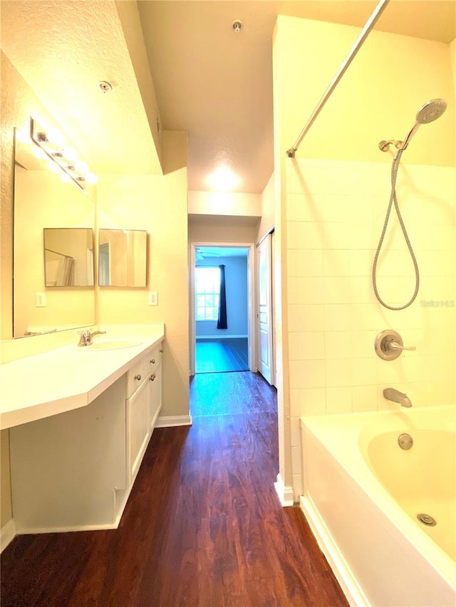 bathroom featuring bathing tub / shower combination, wood-type flooring, and vanity