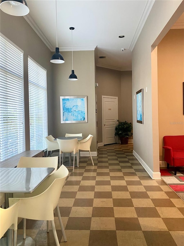 dining space featuring crown molding