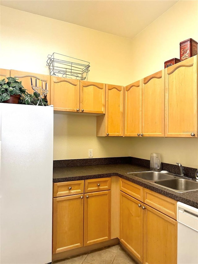 kitchen with light tile patterned flooring, sink, and white appliances