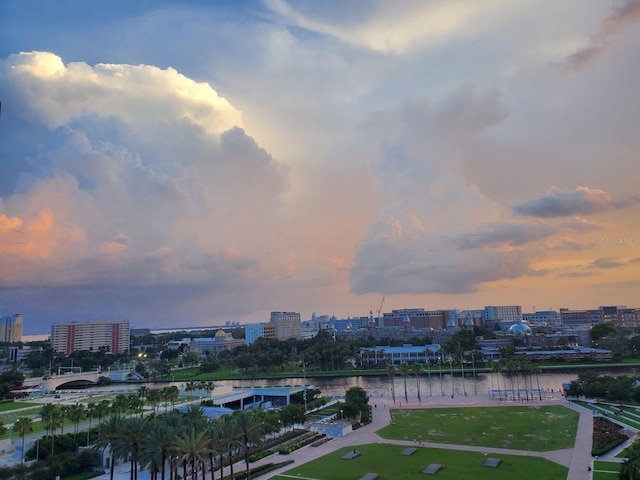 aerial view at dusk featuring a water view