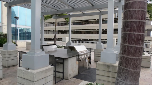 view of patio with a pergola, a grill, and exterior kitchen