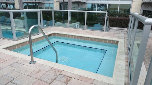 view of pool featuring a hot tub