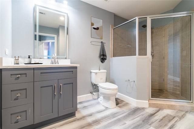 bathroom with vanity, hardwood / wood-style flooring, toilet, and walk in shower