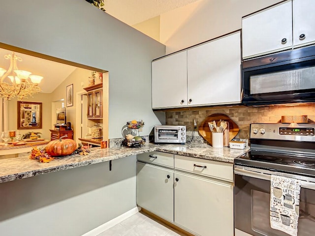 kitchen with lofted ceiling, backsplash, electric range, an inviting chandelier, and light tile floors