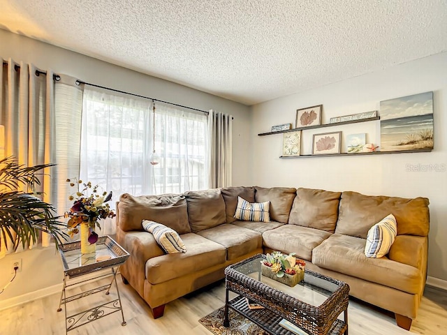 living room featuring light hardwood / wood-style floors and a textured ceiling