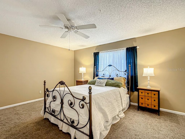 carpeted bedroom featuring a textured ceiling and ceiling fan