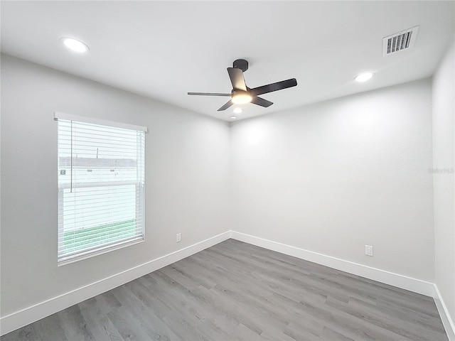 spare room with wood-type flooring and ceiling fan