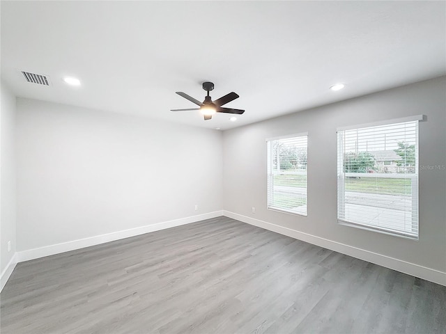 spare room with light hardwood / wood-style floors and ceiling fan