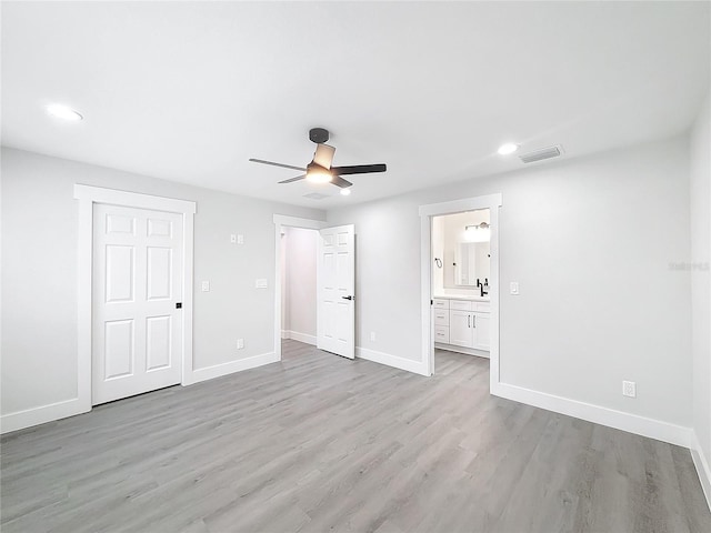 unfurnished bedroom with sink, connected bathroom, ceiling fan, and light hardwood / wood-style flooring