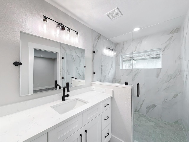 bathroom featuring vanity and an enclosed shower