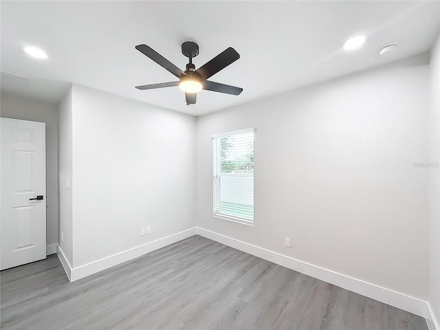 empty room featuring ceiling fan and light hardwood / wood-style floors