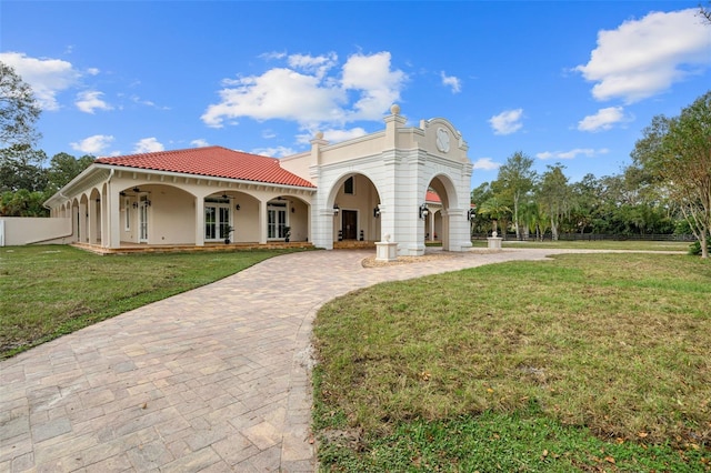 mediterranean / spanish home featuring a front yard