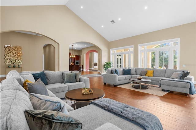 living room featuring hardwood / wood-style floors and high vaulted ceiling