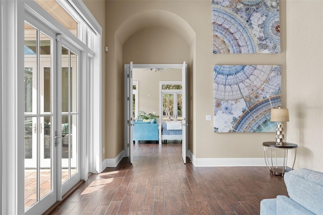 corridor with dark hardwood / wood-style flooring and french doors