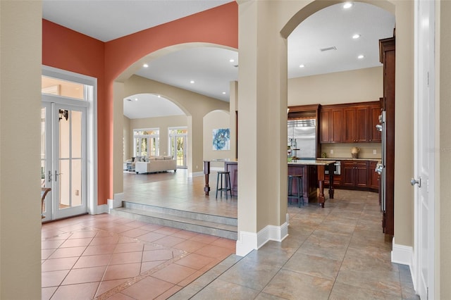 entryway featuring french doors and light tile patterned floors