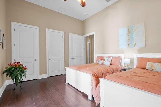 bedroom with dark hardwood / wood-style floors and ceiling fan