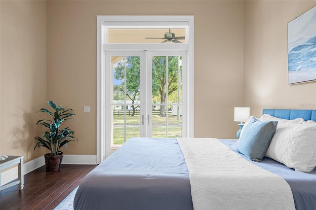 bedroom with dark hardwood / wood-style floors, access to outside, and multiple windows