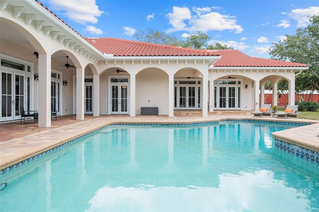 view of pool with french doors, a patio, and ceiling fan