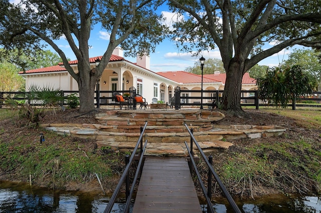 back of property with a water view