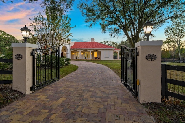 gate at dusk with a yard