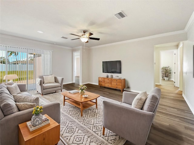 living room with ornamental molding, hardwood / wood-style floors, and ceiling fan