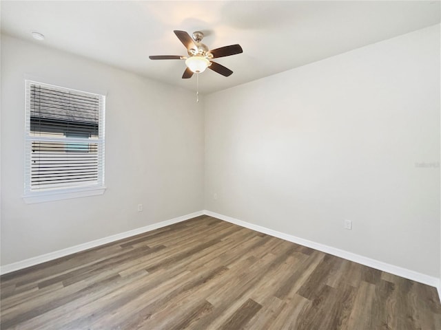 spare room featuring hardwood / wood-style flooring and ceiling fan