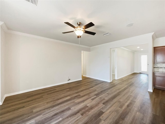 spare room with ceiling fan, ornamental molding, and dark hardwood / wood-style floors