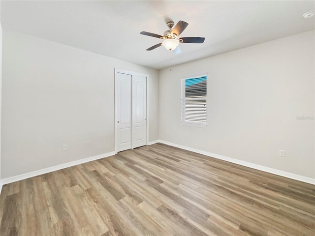 empty room with ceiling fan and light wood-type flooring