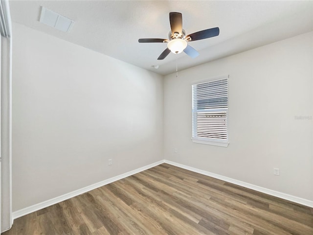 spare room with wood-type flooring and ceiling fan