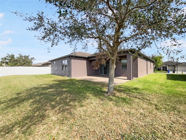 back of house with a yard and a patio area