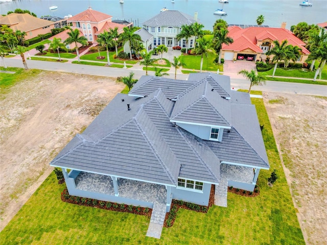 birds eye view of property with a water view