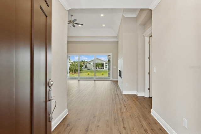 hallway featuring crown molding and light hardwood / wood-style flooring