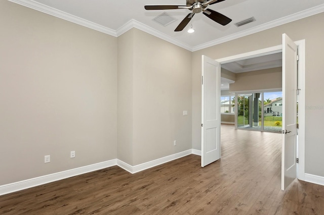 empty room with hardwood / wood-style floors, ceiling fan, and crown molding