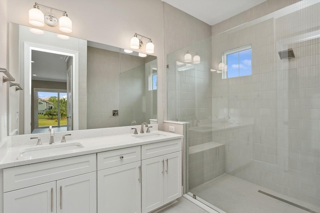 bathroom featuring a tile shower and vanity