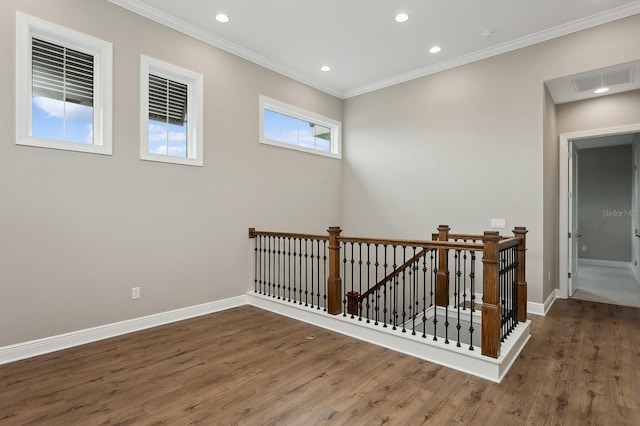 spare room featuring crown molding and dark hardwood / wood-style flooring