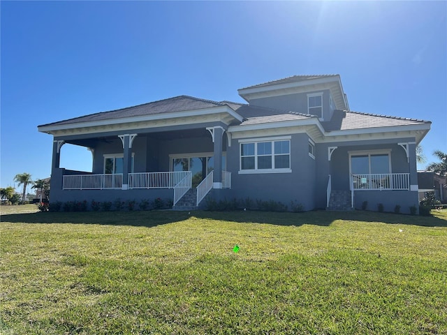 view of front facade featuring covered porch and a front yard