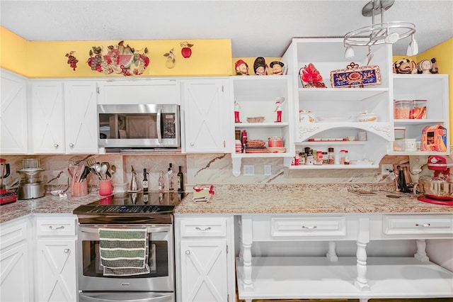 kitchen with white cabinetry, backsplash, and stainless steel appliances