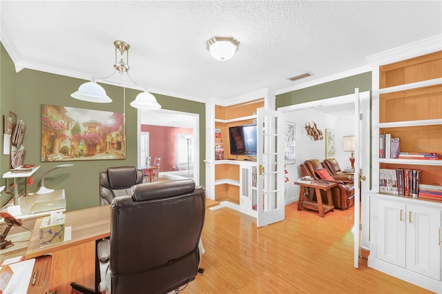 home office with a textured ceiling, ornamental molding, and light hardwood / wood-style flooring