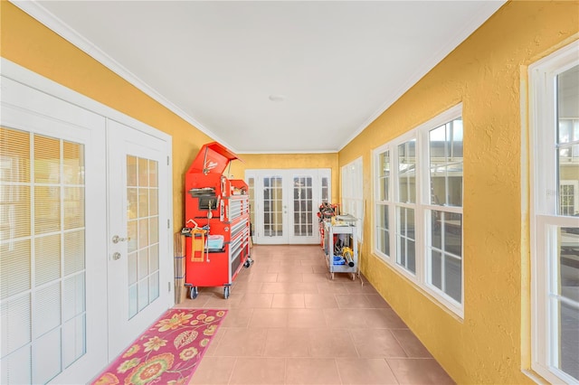 sunroom / solarium featuring french doors