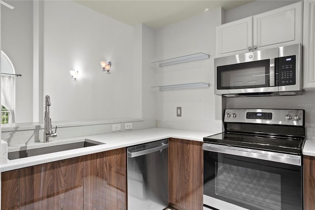 kitchen with white cabinets, stainless steel appliances, and sink