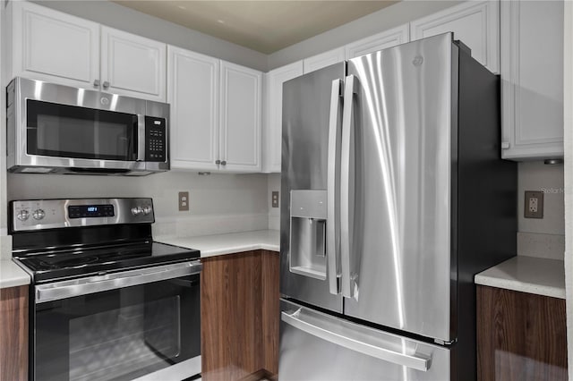 kitchen featuring white cabinets and appliances with stainless steel finishes