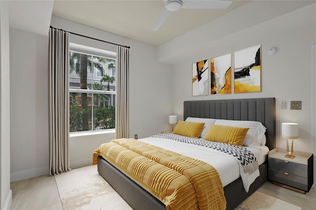 tiled bedroom featuring ceiling fan and multiple windows