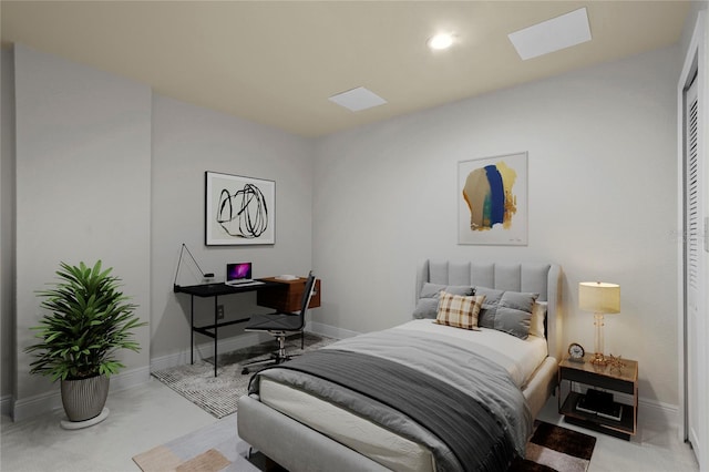 bedroom featuring a skylight and light colored carpet