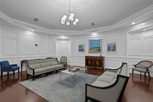 living room featuring a chandelier, dark hardwood / wood-style flooring, and crown molding