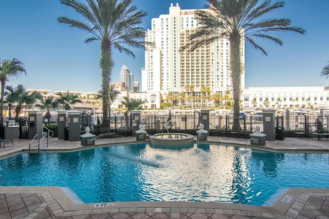 view of swimming pool with a patio and a hot tub