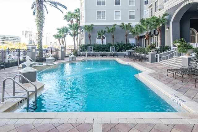 view of pool featuring pool water feature and a patio area