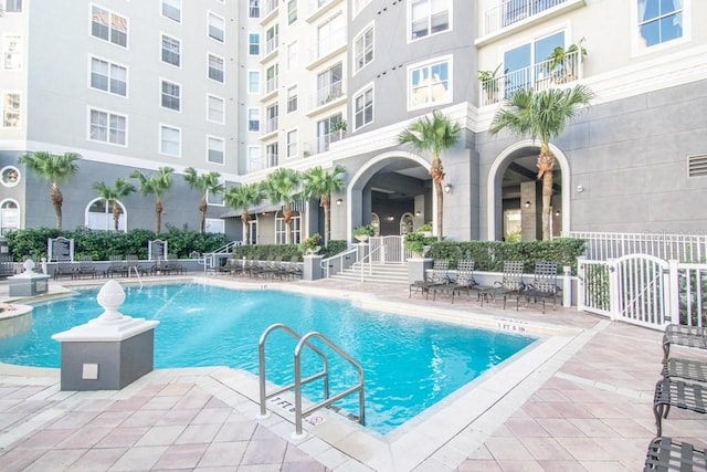 view of pool featuring pool water feature and a patio area